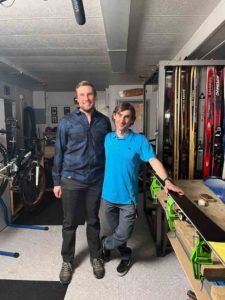 CASSC program director, Lanny Donde, and alum, Adam posing in the ski shop at Calgary Academy