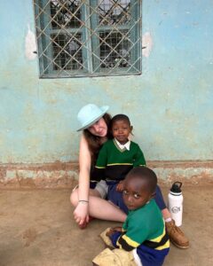 Calgary Academy student sitting with Tanzanian students in the International Travel Studies program