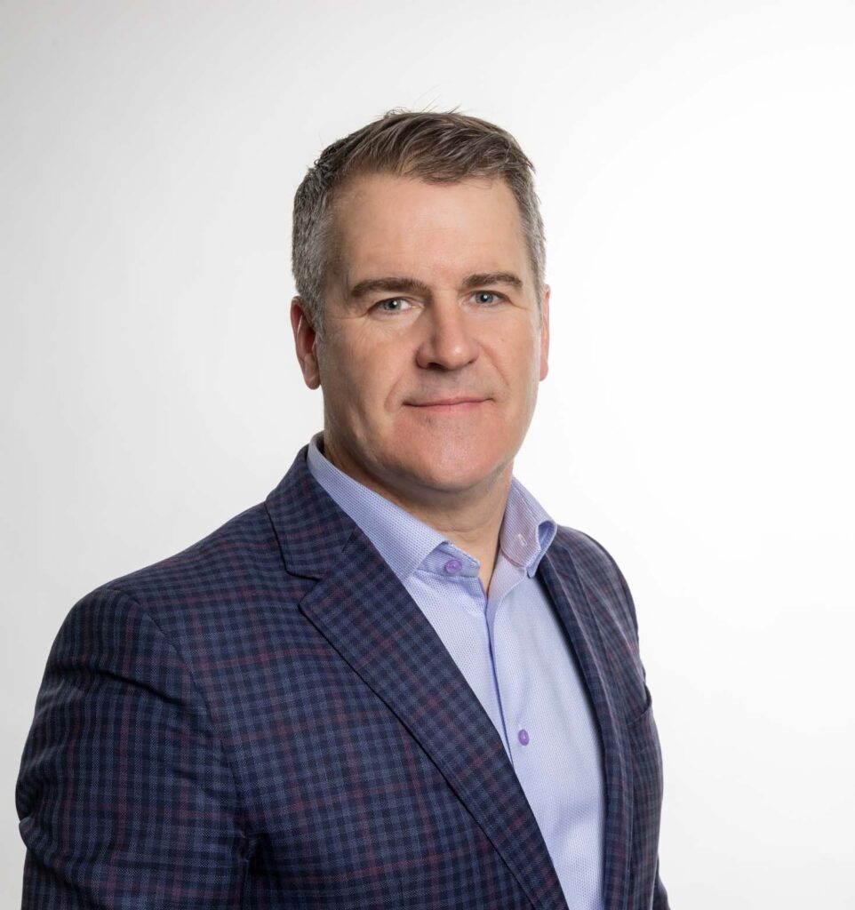 Board Member Pauls Skeans smiles for a photo.