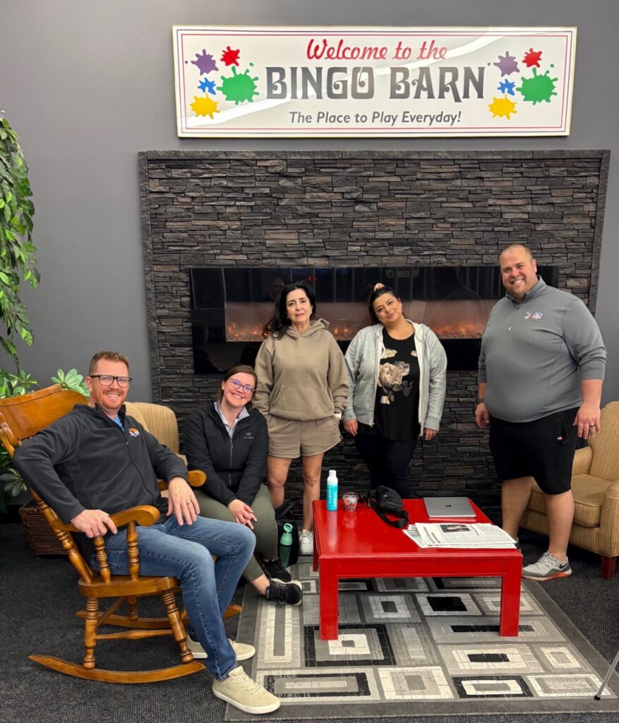 Staff members volunteering at a bingo event. 